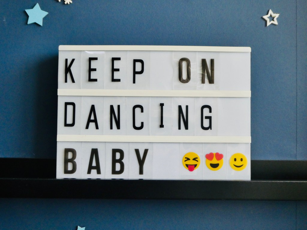 Lightbox Quote displaying message Keep on Dancing Baby with navy blue background and stars
